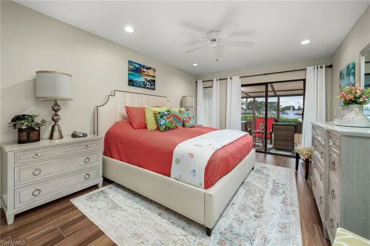 Bedroom with ceiling fan, access to outside, and dark hardwood / wood-style flooring
