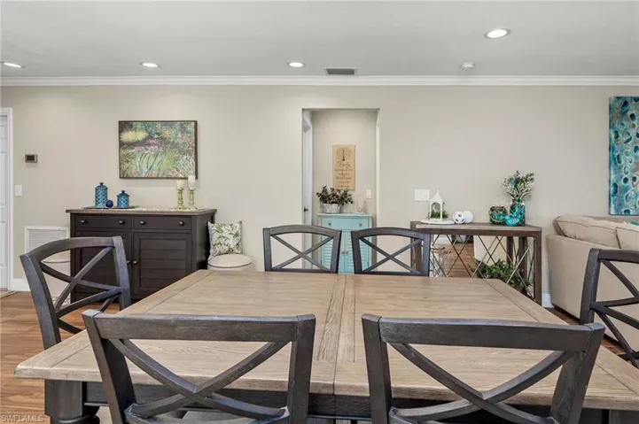Dining area featuring ornamental molding and light hardwood / wood-style flooring