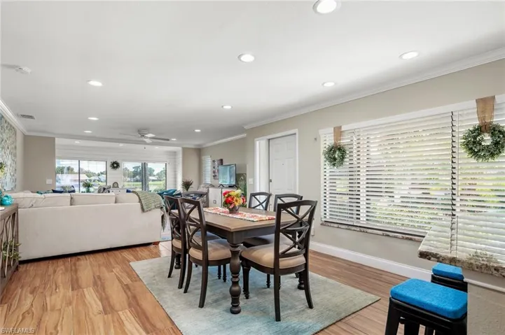 Dining area featuring crown molding, light hardwood / wood-style floors, and ceiling fan