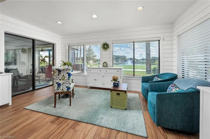 Living room featuring wood-type flooring and wood walls
