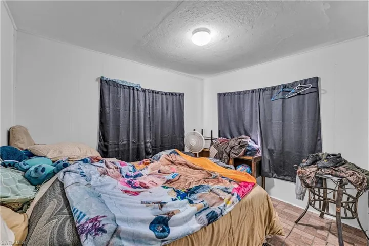 Bedroom with a textured ceiling