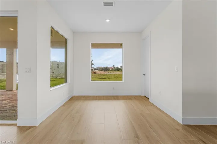 Unfurnished room with light hardwood / wood-style floors