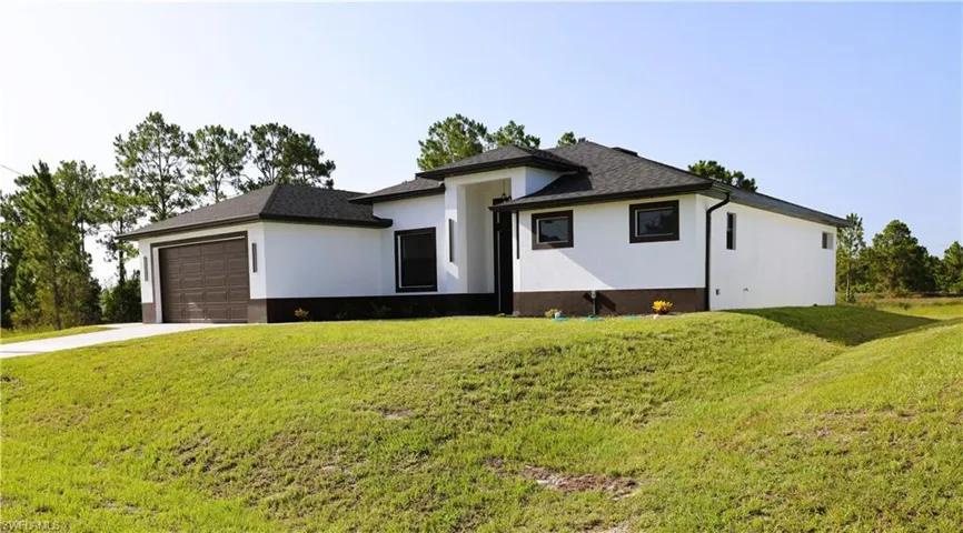 Contemporary architectural style with a white stucco exterior and dark trim