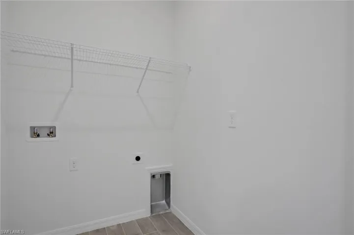 Laundry room featuring hookup for a washing machine, electric dryer hookup, and wood finish floors