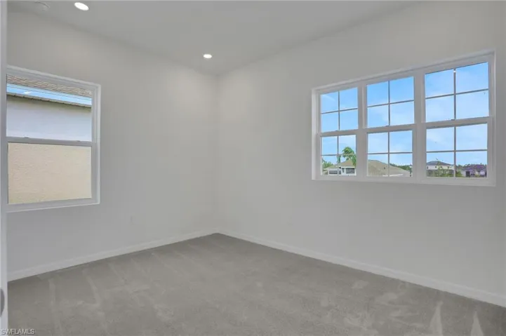 Spare room featuring light carpet and recessed lighting