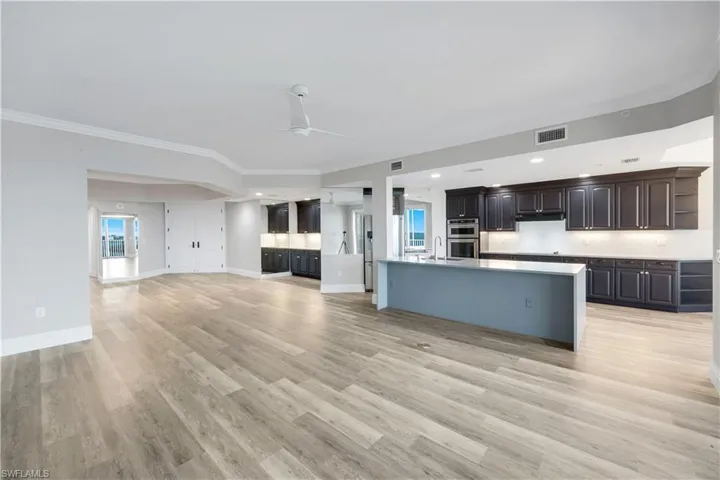 Expansive open-concept living area featuring wood-finish flooring throughout