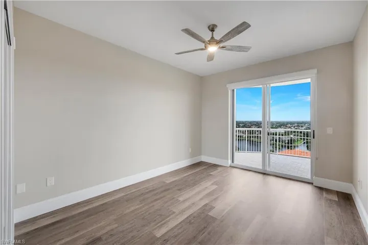 Bedroom #2 featuring wood-finish flooring and a ceiling fan