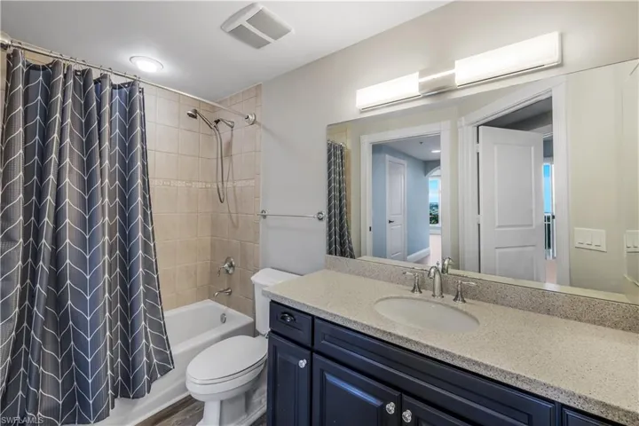 Bathroom featuring a dark wood vanity with a light speckled countertop, undermount sink, and chrome faucet. "Jack & Jill" accessible from Bedroom #3 or from hallway outside of den.
