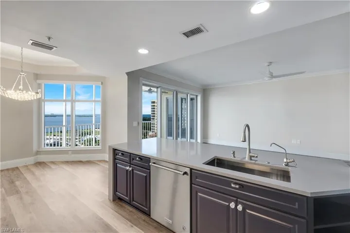 Gourmet kitchen island with an undermount stainless steel sink, pull-down faucet, integrated dishwasher, and ample counter space