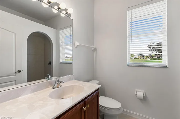 Bathroom with vanity and tiled shower