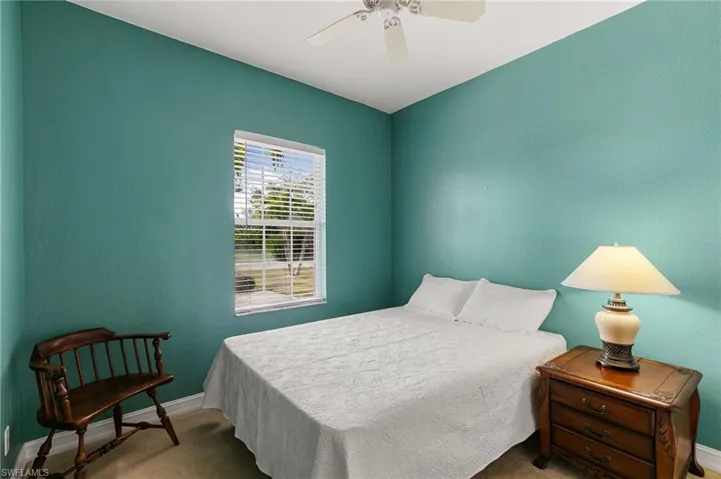 Bedroom featuring a ceiling fan and carpet flooring