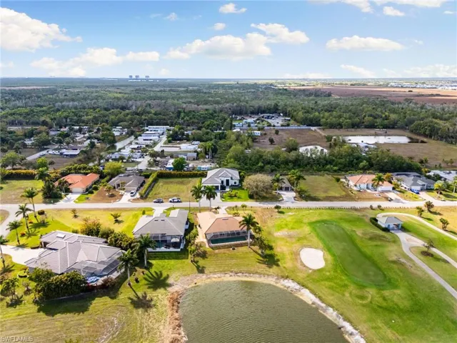 Aerial view of property's location featuring nearby suburban area and a large body of water