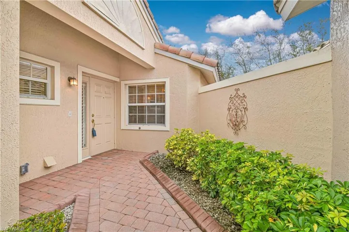 “Inviting front entry with upgraded paver walkway and charming architectural details.”