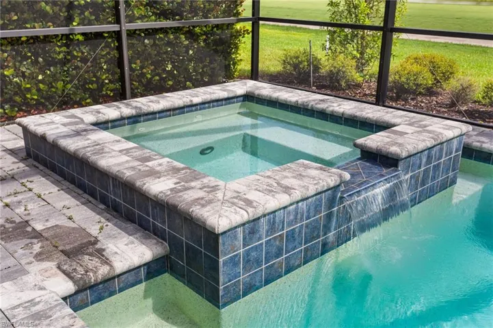 View of pool featuring an in-ground hot tub and a lanai