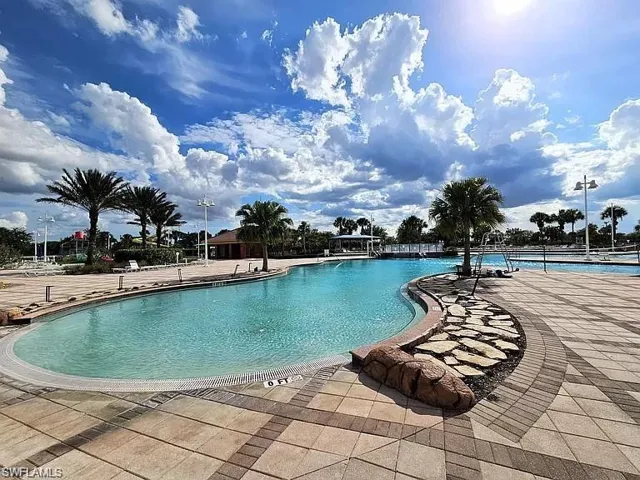 Community pool featuring a patio