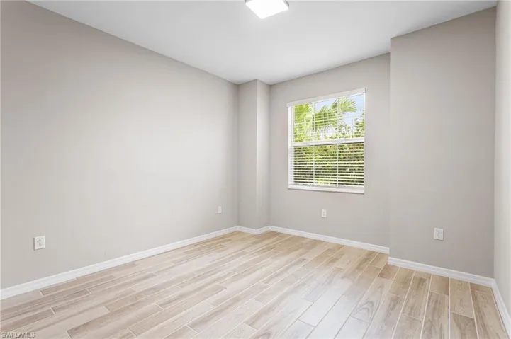 Empty room featuring light wood finished floors and baseboards