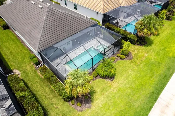 Aerial view of property and surrounding area with a pool area