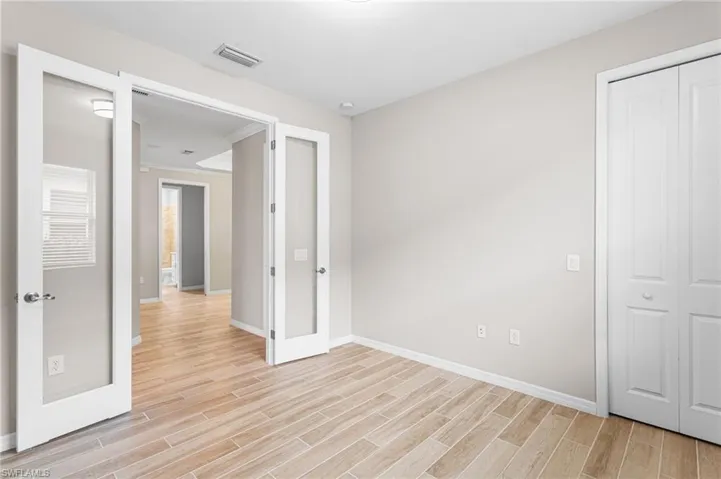 Unfurnished bedroom with light wood-style flooring and a closet