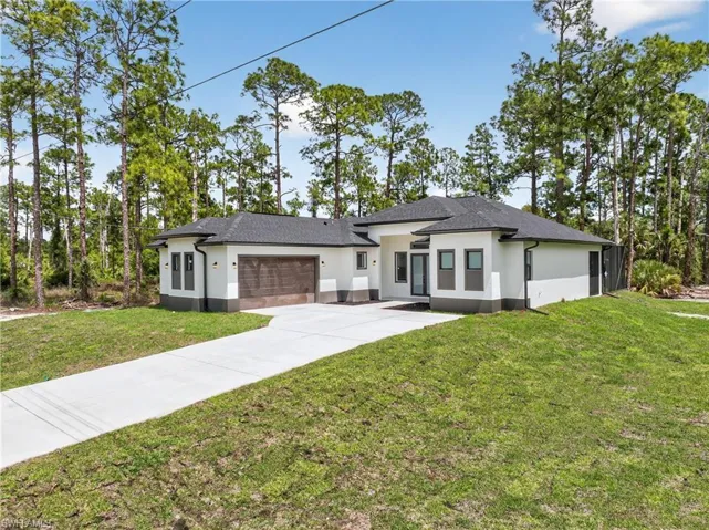 Contemporary single-story residence featuring a dark gray shingle roof and white stucco exterior with a contrasting dark gray base