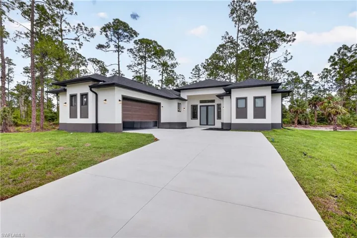 Modern exterior with a light stucco finish and dark trim accents
