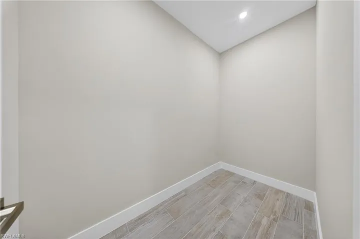 Recessed lighting illuminates neutral-toned walls