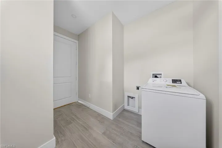 Utility area featuring wood-finish tile flooring and recessed lighting