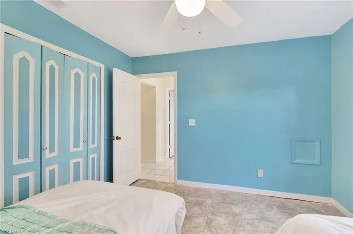 Tiled bedroom featuring a closet and ceiling fan