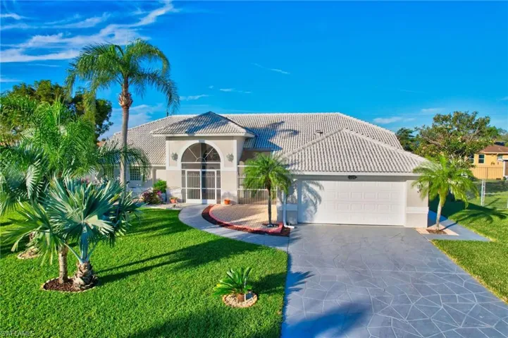 Mediterranean / spanish-style home featuring a front lawn and a garage