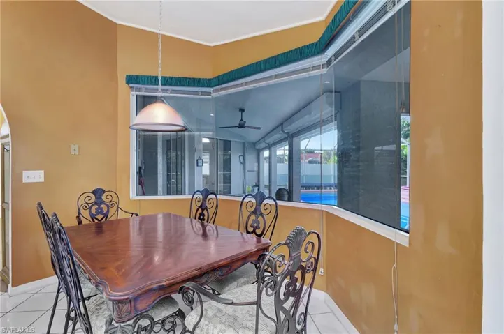 Dining space featuring ceiling fan and light tile patterned floors