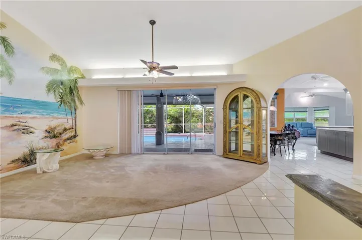 Unfurnished living room featuring plenty of natural light, ceiling fan, light carpet, and french doors