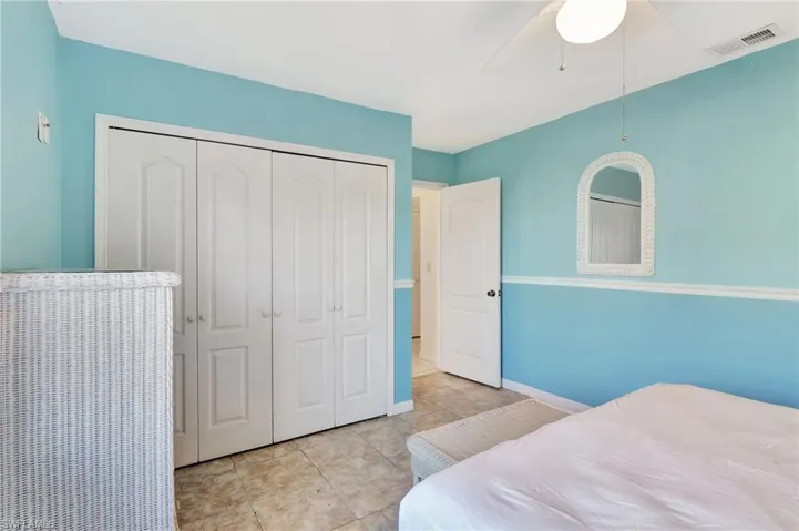Bedroom with ceiling fan and a closet