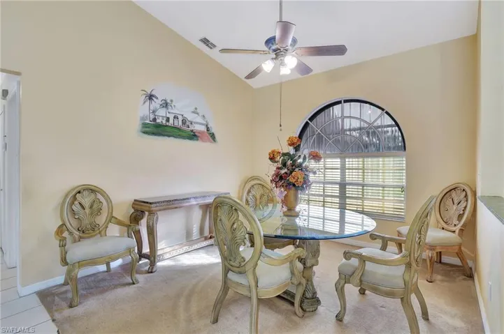 Dining space featuring ceiling fan and lofted ceiling