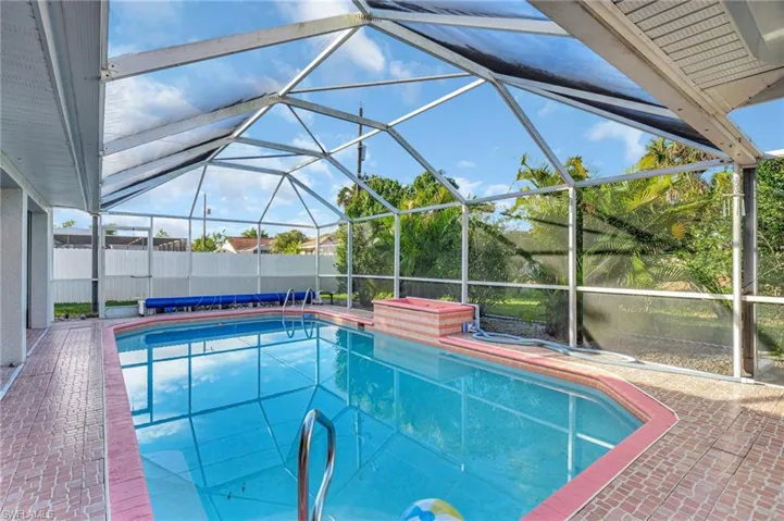 View of swimming pool with a patio area and a lanai