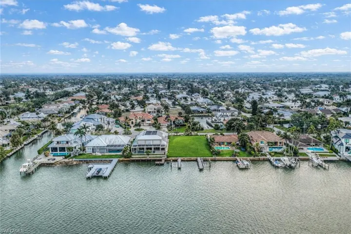 Aerial view of residential area featuring a large body of water