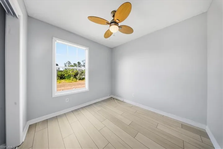 Unfurnished room with wood tiled floors and ceiling fan