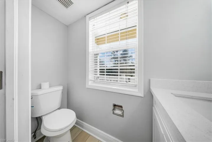 Half bathroom featuring vanity and light wood finished floors