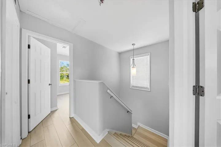 Staircase with baseboards and wood finished floors
