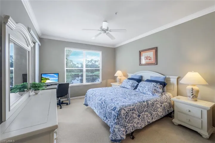 Bedroom featuring crown molding, carpet floors, an office area, and ceiling fan
