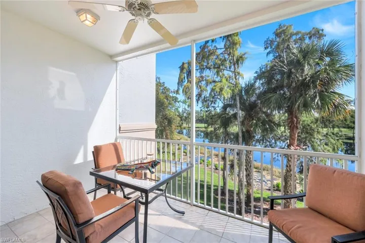 Balcony featuring a ceiling fan and a water view