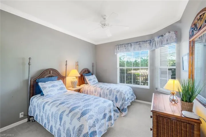 Bedroom featuring crown molding, carpet flooring, and a ceiling fan
