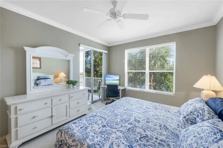 Bedroom with ornamental molding, access to outside, a ceiling fan, and light colored carpet
