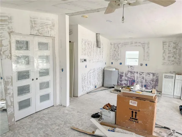 Living area with french doors to bedroom and new cabinets