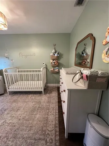 Bedroom with visible vents and baseboards