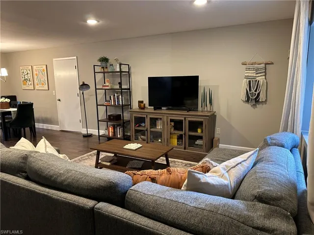 Living area with recessed lighting, baseboards, and wood finished floors