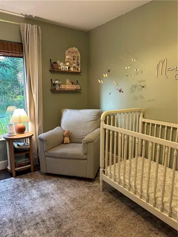 Carpeted bedroom with a crib