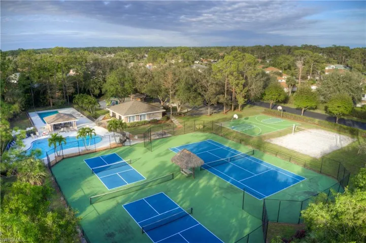 Drone fly by of community amenities showing clubhouse