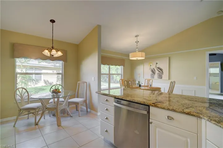 Open Kitchen dining area featuring stone counters, and dining  area