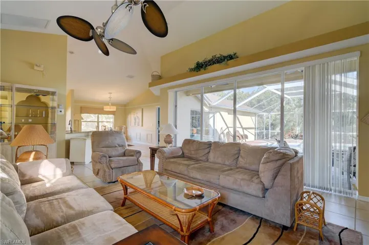Wide view of lanai and pool from open living area