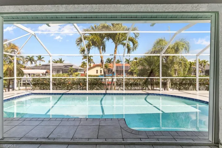 Outdoor pool with a sunroom and glass enclosure