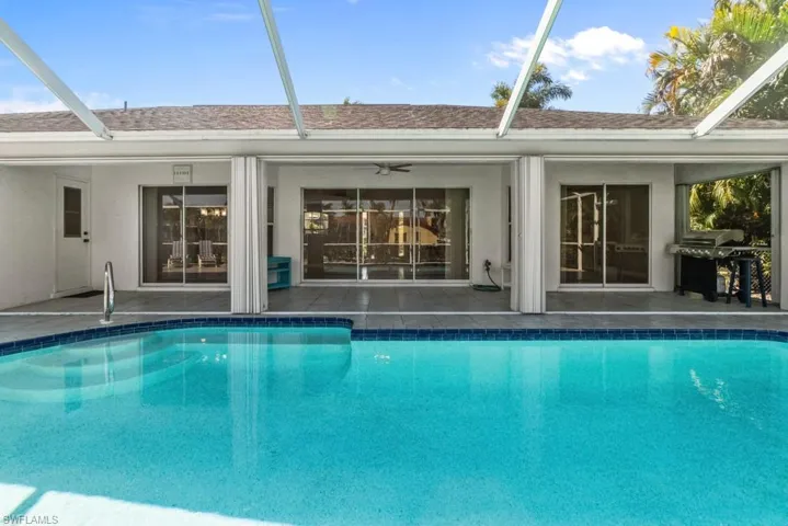 Swimming pool featuring a patio area, grilling area, and a lanai